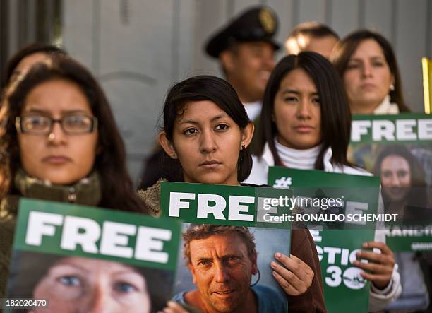 Greenpeace activists protest on September 27, 2013 in front of the Russian embassy in Mexico City, with signs calling for the release of activists...