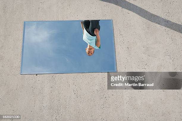 woman standing above mirror and reflection outdoors - delusione stock pictures, royalty-free photos & images