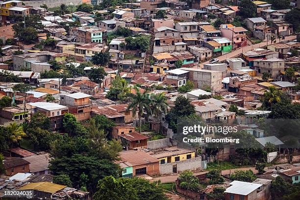Houses stand in a favela in Tegucigalpa, Honduras, on Tuesday, Sept. 3, 2013. Economic growth in Honduras is forecast to slow to 3 percent this year...