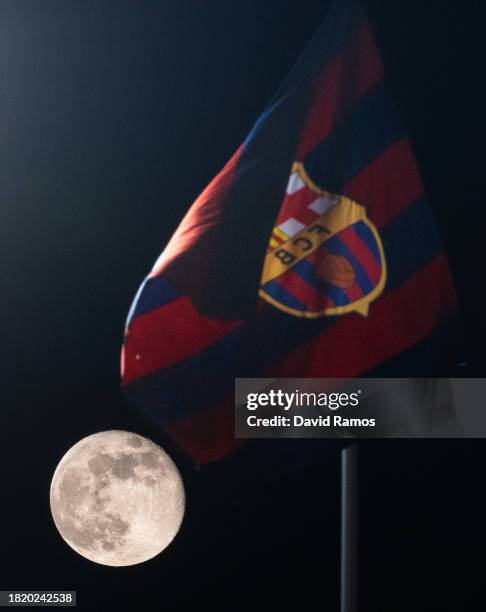 View of the moon alongside an FC Barcelona flag ahead of the UEFA Champions League match between FC Barcelona and FC Porto at Estadi Olimpic Lluis...