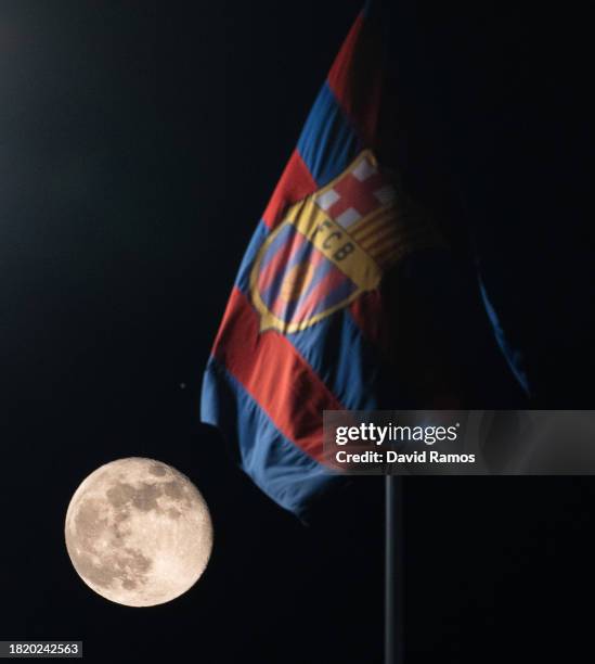 View of the moon alongside an FC Barcelona flag ahead of the UEFA Champions League match between FC Barcelona and FC Porto at Estadi Olimpic Lluis...