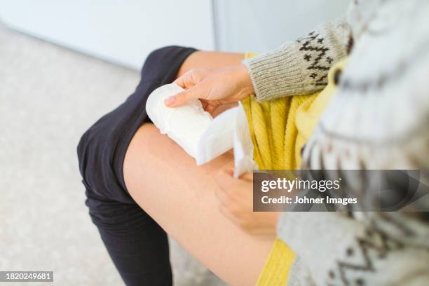 woman using sanitary pad in bathroom - damenbinde stock-fotos und bilder