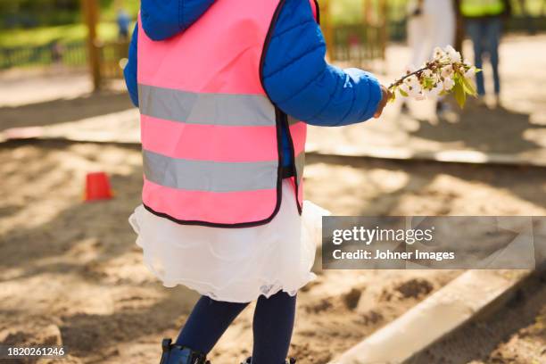 girl wearing pink vest in park - sandlåda bildbanksfoton och bilder