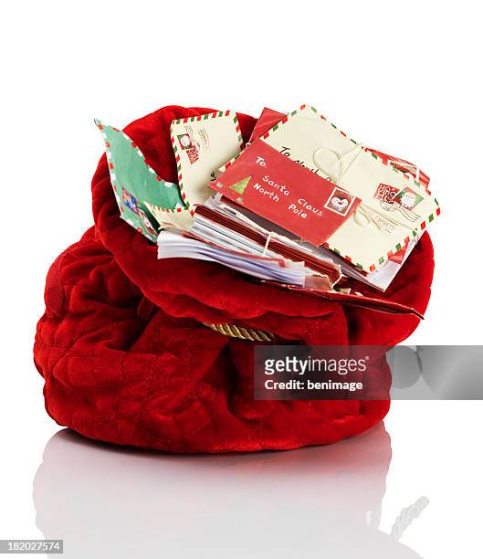 red santa claus mailbag stuffed with letters - santa suit stock pictures, royalty-free photos & images
