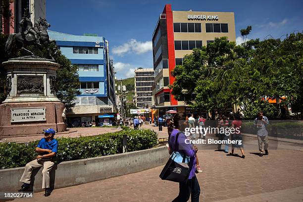 People walk in Central Park in Tegucigalpa, Honduras, on Thursday, Sept. 5, 2013. Economic growth in Honduras is forecast to slow to 3 percent this...