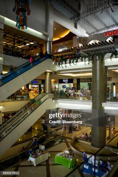 Shoppers walk in a mall in the Los Proceres section of Tegucigalpa, Honduras, on Saturday, Sept. 7, 2013. Economic growth in Honduras is forecast to...