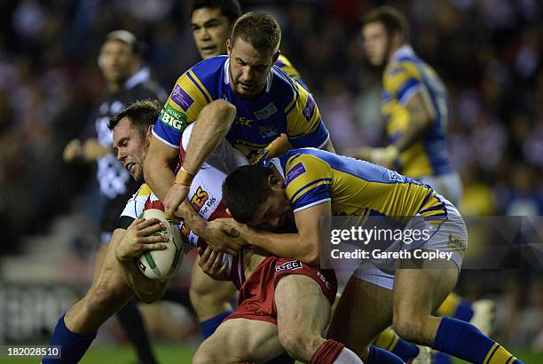 Pat Richards of Wigan is tackled by Mitch Achurch and Chris Clarkson of Leeds during the Super League Qualifying Semi Final match between Wigan...