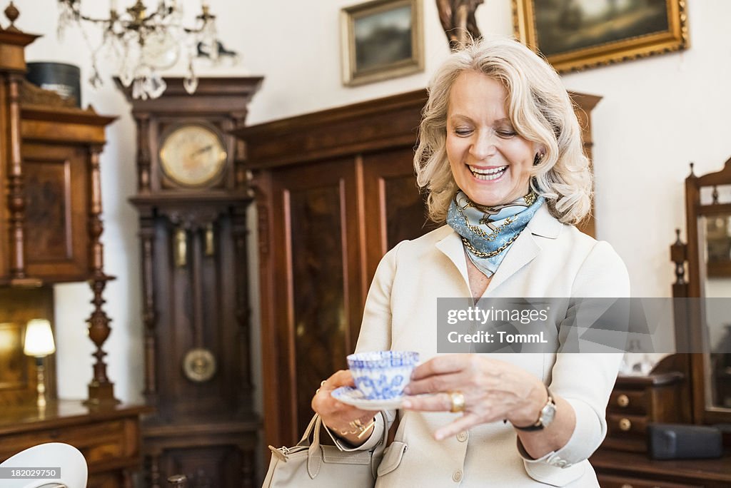 Happy Mature Woman in Antique Store