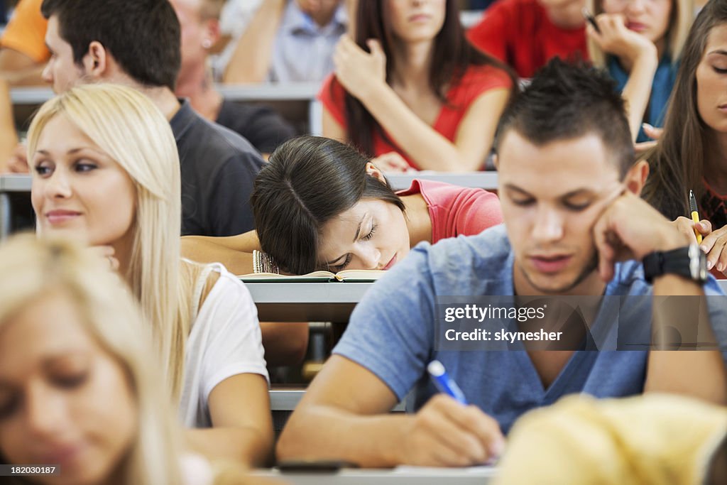 Young female student sleeping during a lecture.