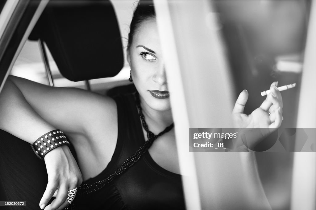 Beautiful woman in the car looks with contempt