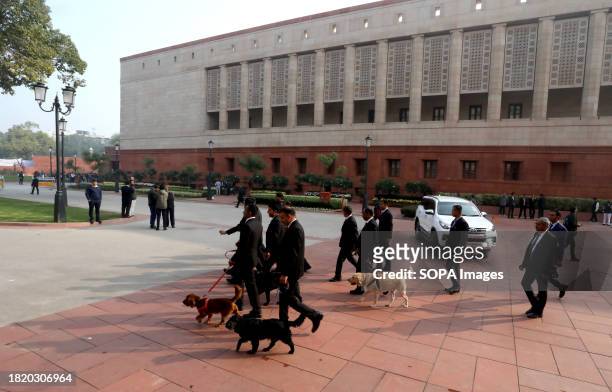 Indian parliament security staff and sniffer dogs seen outside the new building of Parliament on the first day of the Parliament winter session 2023,...