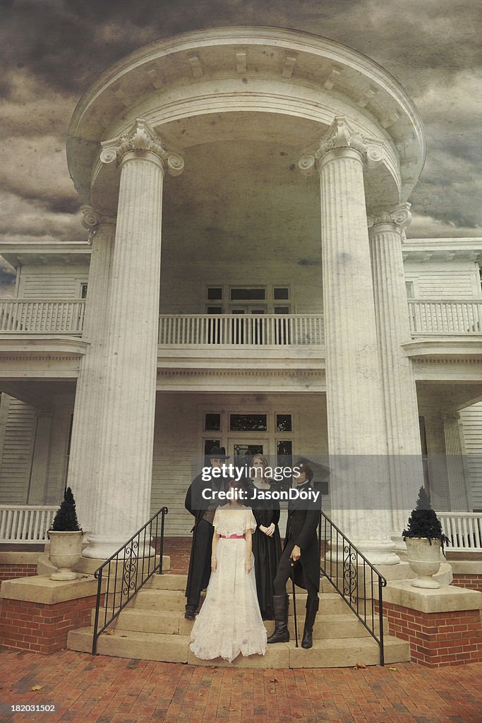 Creepy Family Outside of Neo Classical Home