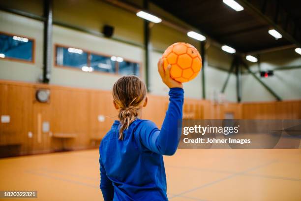 rear view of girl holding handball in sports court - västra götaland county stock pictures, royalty-free photos & images