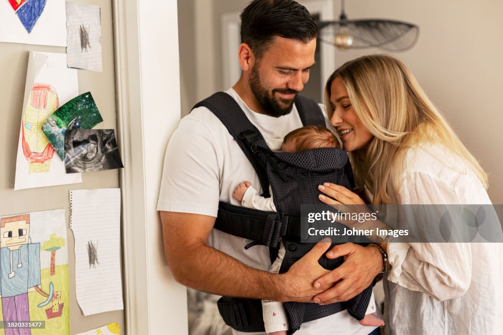 Happy parents spending leisure time with son at home