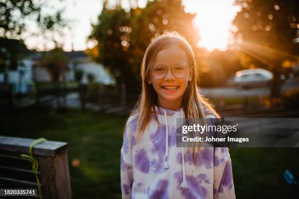 portrait of happy girl wearing hoodie during sunset - västra götaland county stock pictures, royalty-free photos & images