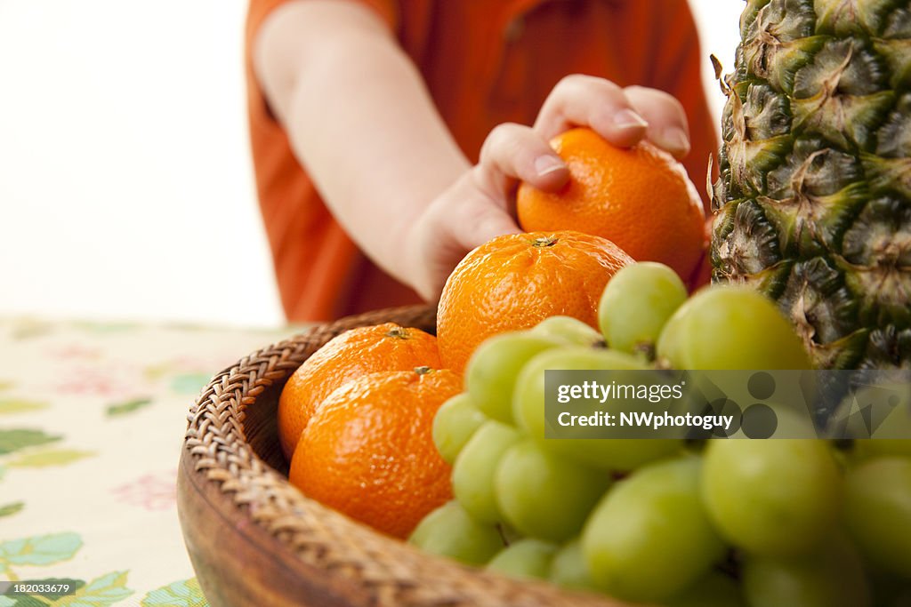 Child Eating Healthy Fruit Basket