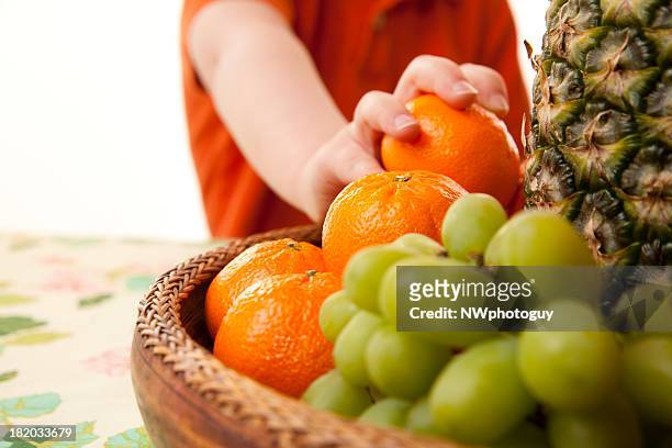 child eating healthy fruit basket - fruit bowl stock pictures, royalty-free photos & images