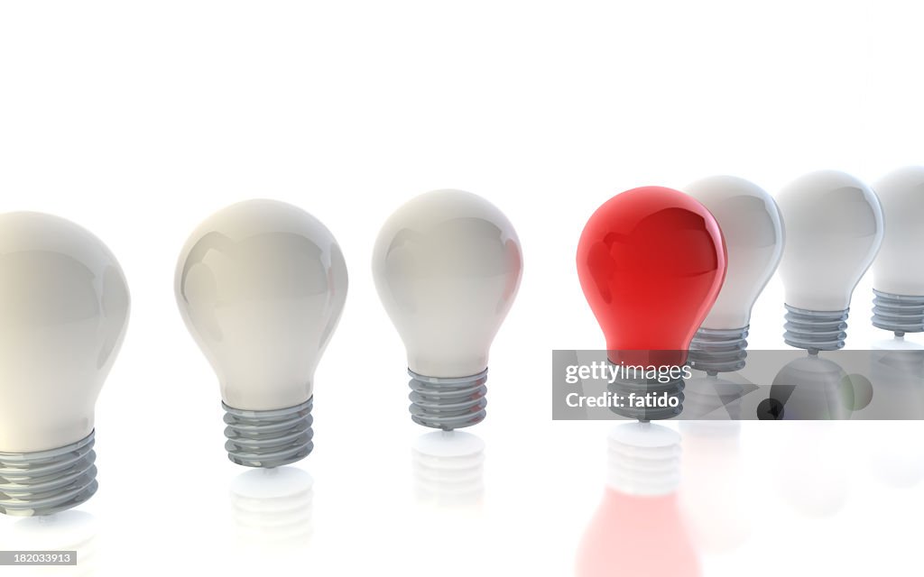 A red lightbulb standing out from crowd of white lightbulbs