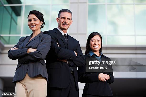 team of businesspeople standing outside office building - 3 men standing outside stock pictures, royalty-free photos & images