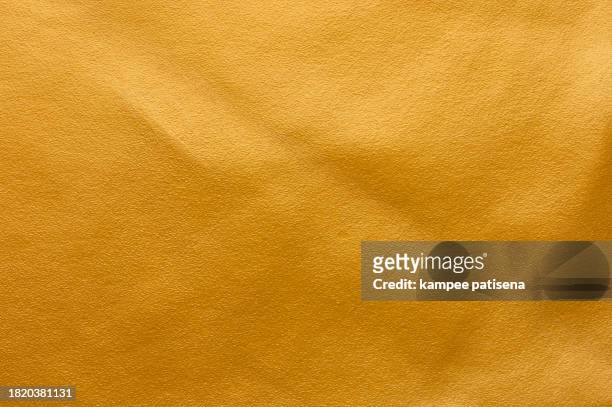 full frame shot of gold colored leather background texture high resolution - goldene jacke stock-fotos und bilder