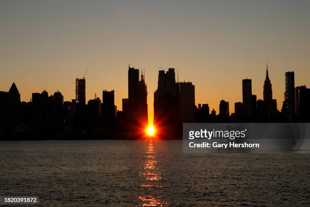 The sun rises over 42nd street during a sunrise Manhattanhenge in New York City on November 29 as seen from Weehawken, New Jersey.