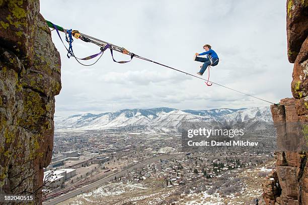 pro slack/high liner doing a grab on a highline. - glen haven co stock pictures, royalty-free photos & images