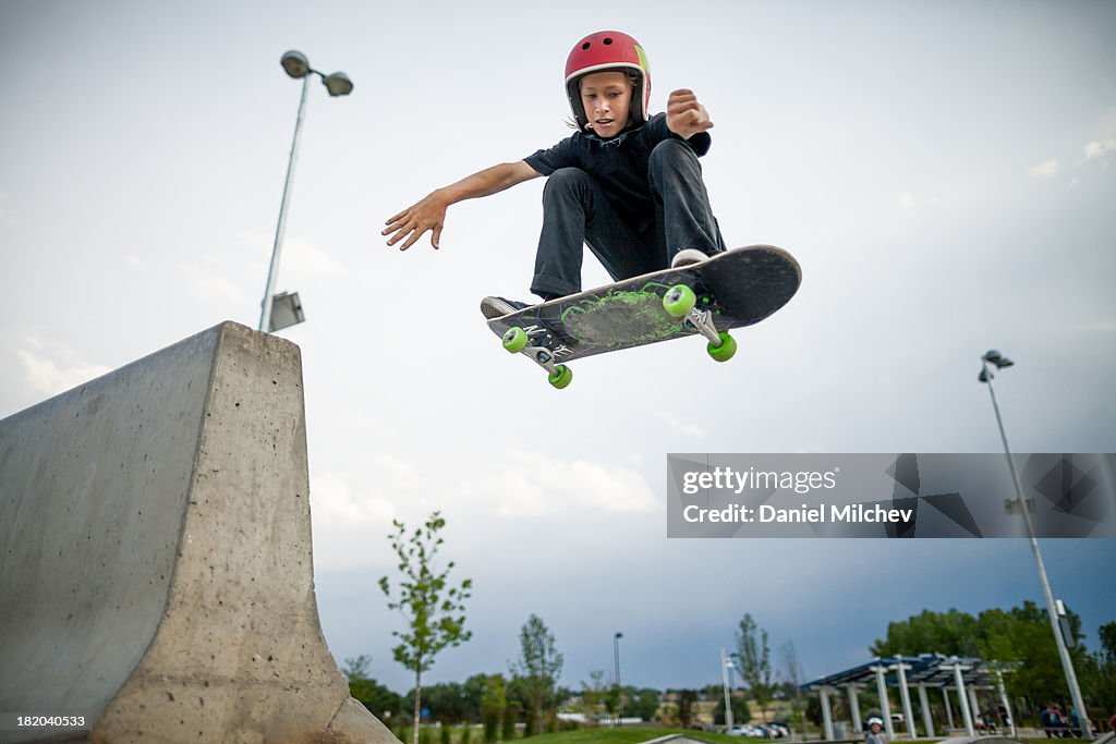 Kid, having fun skateboardin and jumping.