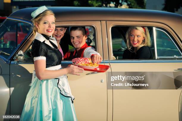 fifties drive in with car hop and customers - pillbox hat stock pictures, royalty-free photos & images