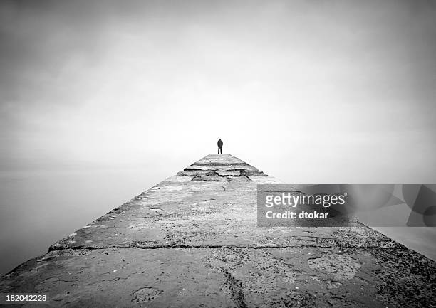 man on the edge of pier - landscape black and white stockfoto's en -beelden