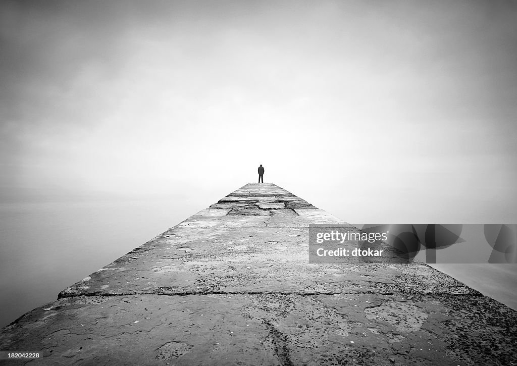 Man on the edge of pier