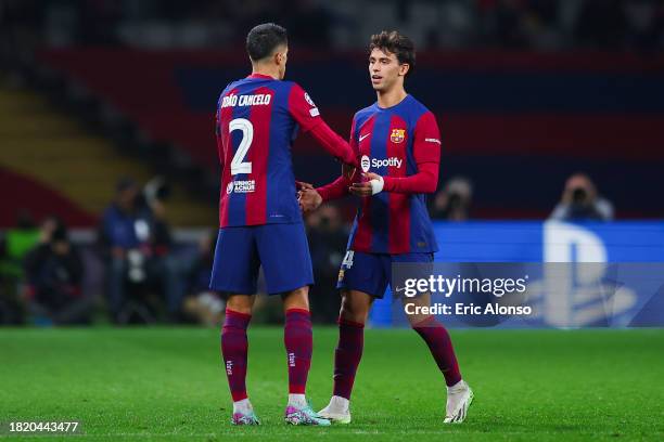 Joao Felix of FC Barcelona interacts with Joao Cancelo of FC Barcelona during the UEFA Champions League match between FC Barcelona and FC Porto at...