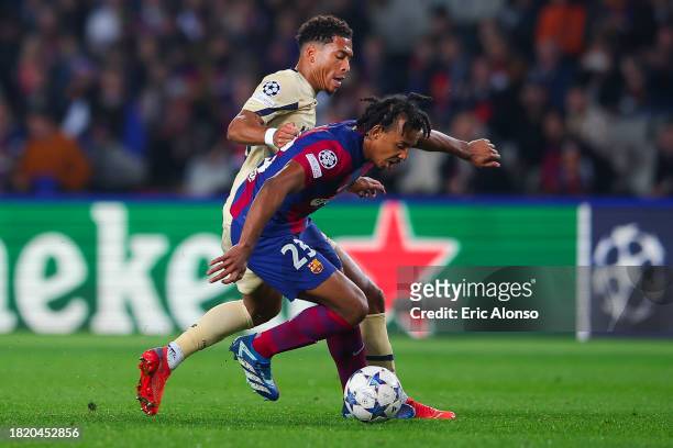 Jules Kounde of FC Barcelona is tackled by Danny Namaso of FC Porto during the UEFA Champions League match between FC Barcelona and FC Porto at...