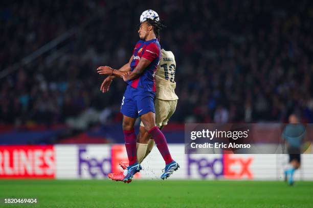 Jules Kounde of FC Barcelona is tackled by Danny Namaso of FC Porto during the UEFA Champions League match between FC Barcelona and FC Porto at...