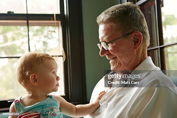 baby girl with her grand father - indiana home stock pictures, royalty-free photos & images