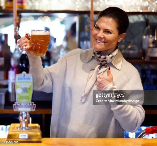 Crown Princess Victoria of Sweden pulls a pint of beer as she visits the Three Blackbirds Pub, Woodditton to meet a pub owner to discuss English pub...