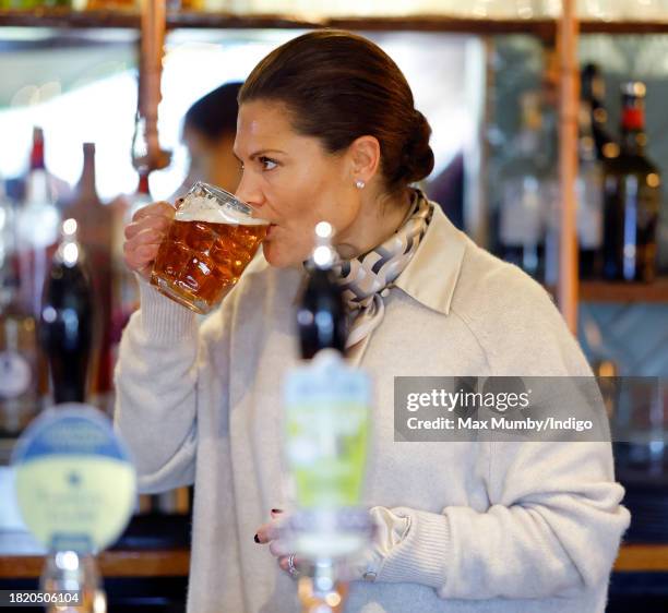 Crown Princess Victoria of Sweden sips a pint of beer she pulled as she visits the Three Blackbirds Pub, Woodditton to meet a pub owner to discuss...