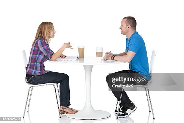 couple sitting in a restaurant - chairs in studio stockfoto's en -beelden