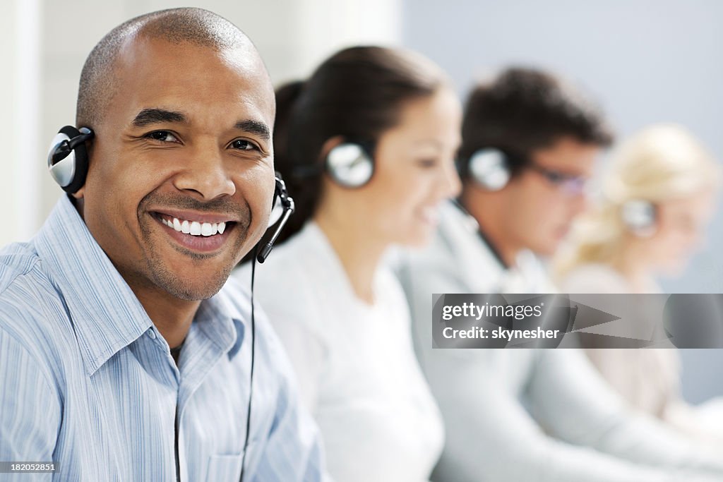 Happy man wearing headset and looking at camera