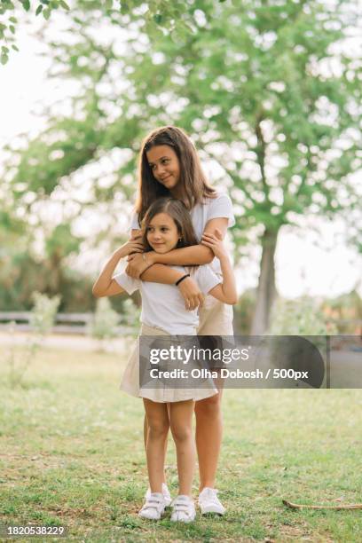 mother and daughter embracing - peel park stock pictures, royalty-free photos & images