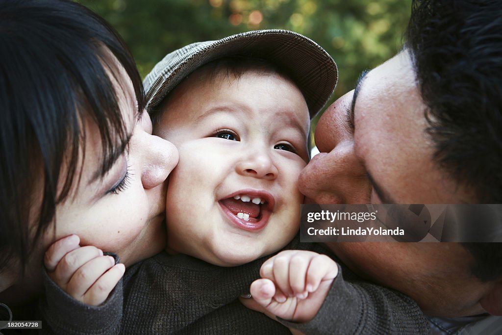 Parents Kissing Child