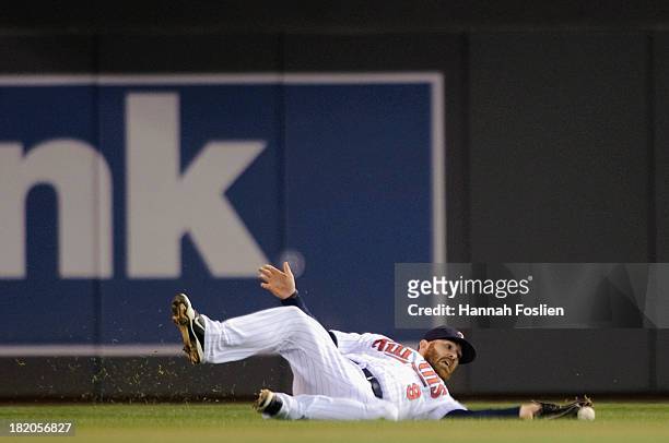 Ryan Doumit of the Minnesota Twins misses a catch an an RBI single off the bat Mike Aviles of the Cleveland Indians during the fifth inning of the...