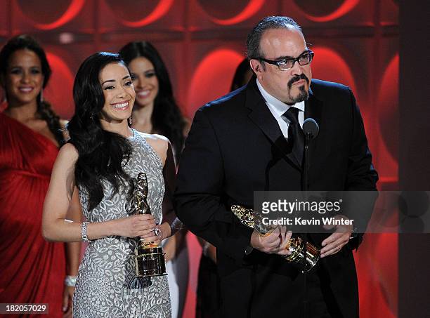 Actors Aimee Garcia and David Zayas accept the Special Achievement in Television award for "Dexter" onstage during the 2013 NCLR ALMA Awards at...