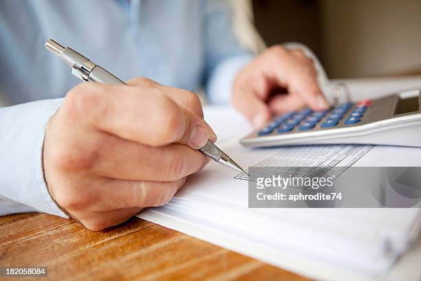 calculating finances - scrutiny stock pictures, royalty-free photos & images