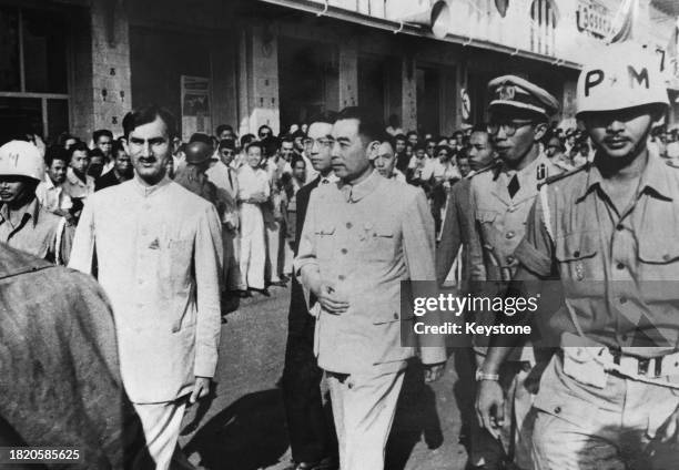 Chinese politician Zhou Enlai, Premier of the People's Republic of China, surrounded by security and bodyguards as he attends the Afro–Asian...