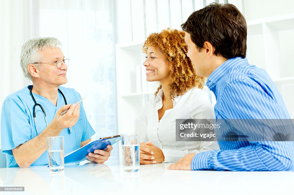 Young couple at doctors office.