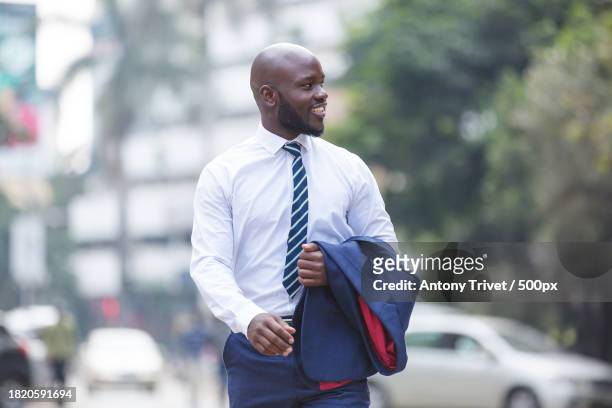businessman walking on street,nairobi,kenya - nairobi county stock pictures, royalty-free photos & images