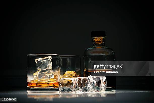 whiskey in glass with ice - whiskey stock pictures, royalty-free photos & images