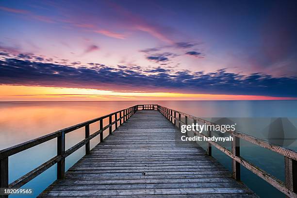 jetty at sunset - pier stock pictures, royalty-free photos & images