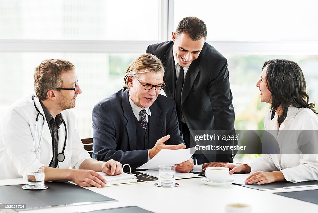 Businessmen having a meeting with doctors.
