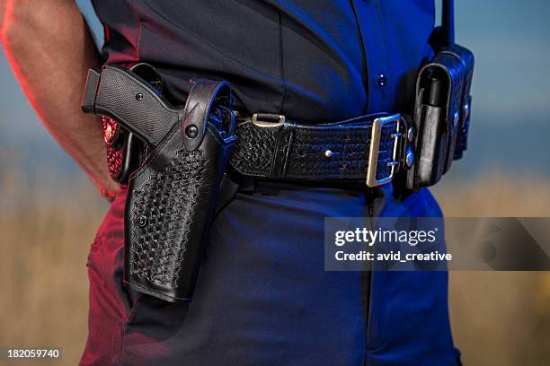 closeup of police officer belt - armed police stockfoto's en -beelden